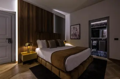 a bedroom with a large bed with a lamp on it at Fontart Tritone in Rome