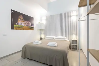 a bedroom with a bed with towels on it at Rome Capital Apartments in Rome