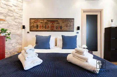 a bedroom with a bed with towels on it at Luxury Vatican Suite with Sauna in Rome