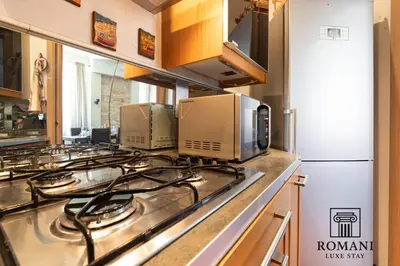 a kitchen with a stove top with several microwaves at Luxury Vatican Suite with Sauna in Rome