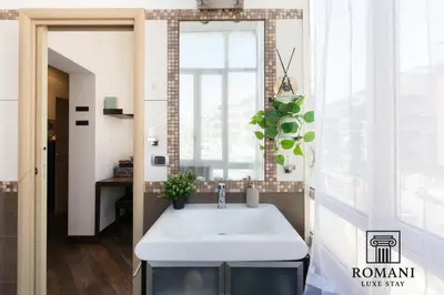 a bathroom with a sink and a window at Luxury Vatican Suite with Sauna in Rome