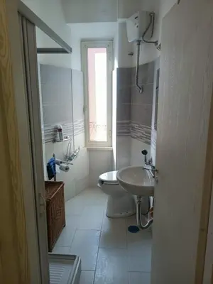 a white bathroom with a sink and a toilet at Testaccio Immobiliare in Rome
