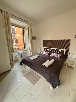 a bedroom with a large bed with brown sheets and pillows at Testaccio Immobiliare in Rome