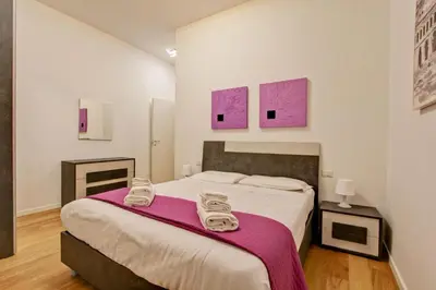 a bedroom with a bed with two towels on it at Poliziano Boutique Apartment in Rome