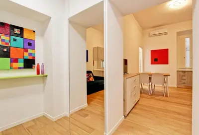 a room with a kitchen and a dining room at Poliziano Boutique Apartment in Rome