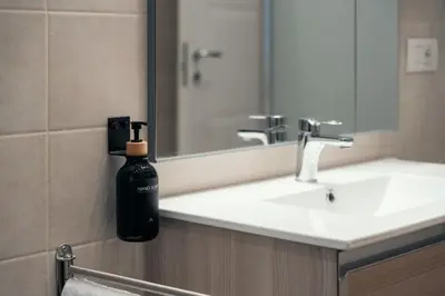 a bathroom with a black soap bottle on a sink at Casa Mia San Pietro in Rome