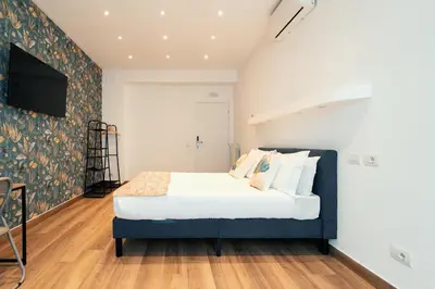 a bedroom with a bed and a tv on a wall at Casa Mia San Pietro in Rome