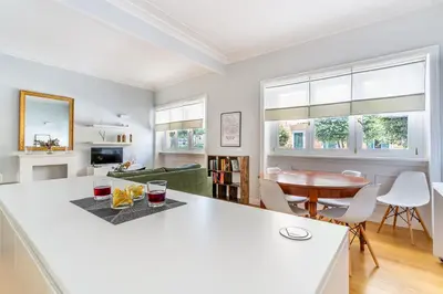 a kitchen and living room with a table and chairs at iFlat Charming Hideaway Apt by the Vatican in Rome