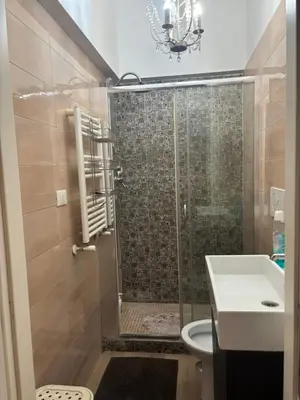 a bathroom with a shower with a toilet and a sink at Locanda di Trastevere in Rome