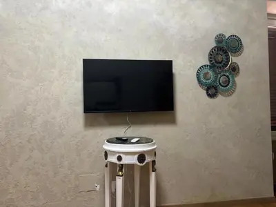 a flat screen tv on a wall with a stool at Locanda di Trastevere in Rome