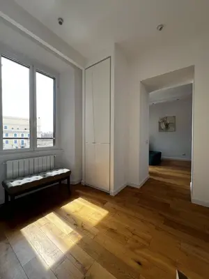 an empty room with a bench on a wooden floor at Zaffiro FIUME charming apartment in Rome