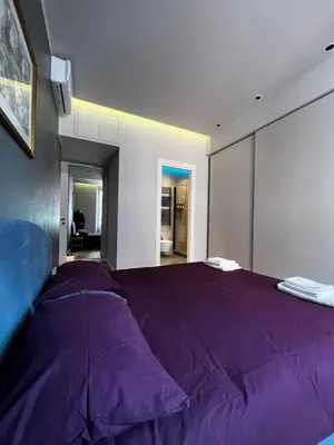 a bedroom with a large purple bed in a room at Zaffiro FIUME charming apartment in Rome