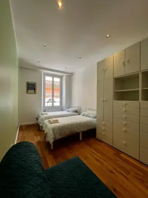 a bedroom with two beds and a large closet at Zaffiro FIUME charming apartment in Rome