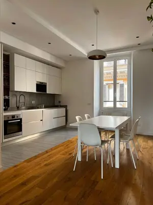 a kitchen with a table and chairs in a room at Zaffiro FIUME charming apartment in Rome