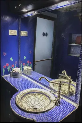 a bathroom with a sink in a blue room at Un cuore nella città eterna in Rome