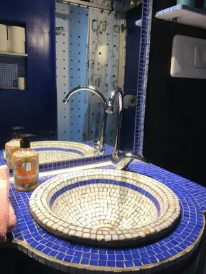 a bathroom with two sinks with a faucet at Un cuore nella città eterna in Rome
