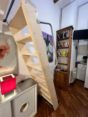 a wooden staircase in a room with a shelf at Un cuore nella città eterna in Rome