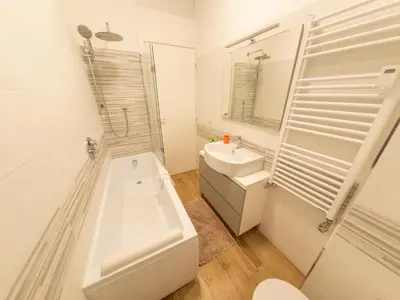 a white bathroom with a sink and a toilet at New Cozy APT, close to Downtown in Rome