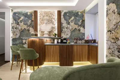 a bar in the middle of a room with green chairs at Antinous Suites in Rome