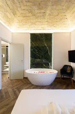 a bathroom with a large white tub in a room at Antinous Suites in Rome