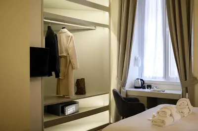 a hotel room with a bed and a window at Antinous Suites in Rome