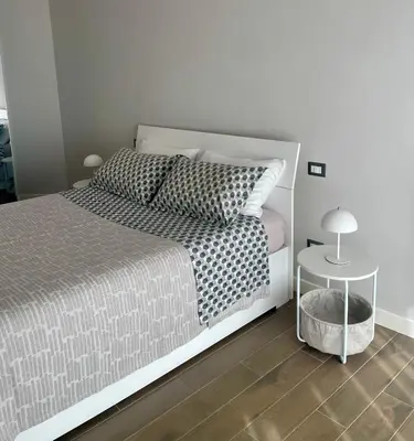 a bedroom with a bed and a side table at I Love San Pietro in Rome