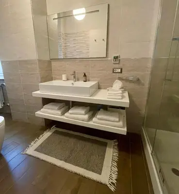 a white bathroom with a sink and a shower at I Love San Pietro in Rome