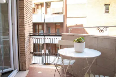 a small white table and chair on a balcony at I Love San Pietro in Rome