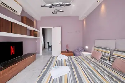 a living room with a tv and a couch at Vatican Apartment 4 Bedrooms AC in Rome