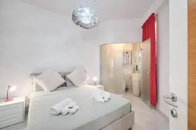 a bedroom with a white bed with towels on it at Vatican Apartment 4 Bedrooms AC in Rome