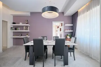 a dining room with purple walls and a table and chairs at Vatican Apartment 4 Bedrooms AC in Rome