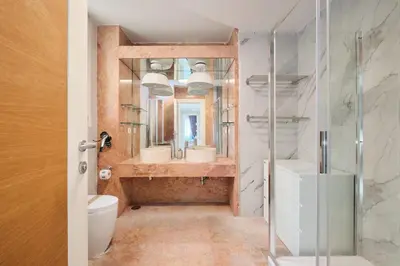 a bathroom with a shower and a toilet and a mirror at Vatican Apartment 4 Bedrooms AC in Rome