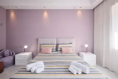 a bedroom with a large bed with pink walls at Vatican Apartment 4 Bedrooms AC in Rome