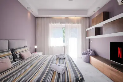 a bedroom with a large bed and a tv at Vatican Apartment 4 Bedrooms AC in Rome