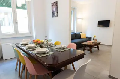 a dining room and living room with a table and chairs at Casa Buon Vento - relax a Villa Ada in Rome