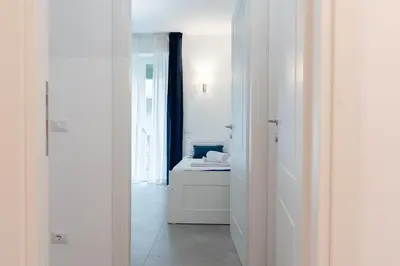 a white hallway with a bed in a room at Casa Buon Vento - relax a Villa Ada in Rome