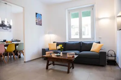a living room with a blue couch and a table at Casa Buon Vento - relax a Villa Ada in Rome
