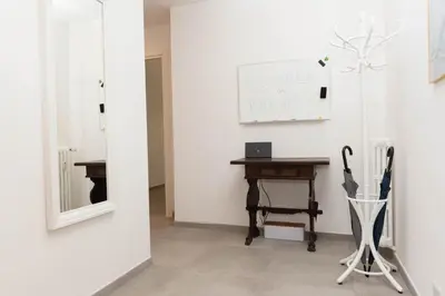 a room with a table and a mirror and a desk at Casa Buon Vento - relax a Villa Ada in Rome