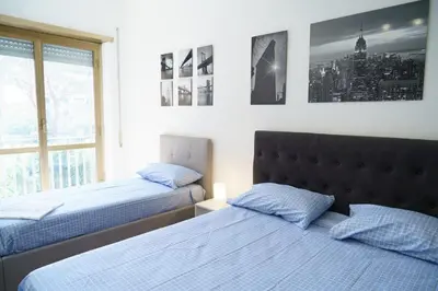 a bedroom with two beds and a window at Apartment16 in Rome