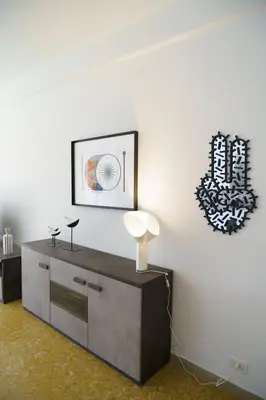 a room with a white wall with a table with a lamp at Apartment16 in Rome