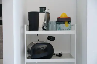 a small tv sitting on a shelf next to a blender at Apartment16 in Rome