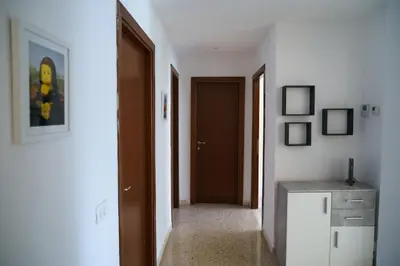 a hallway with a door and a refrigerator in a room at Apartment16 in Rome