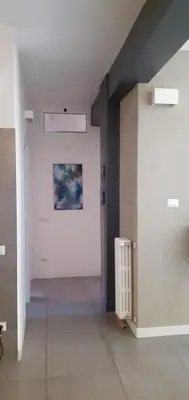 an empty hallway with a painting on the wall at Casa Fradella in Rome