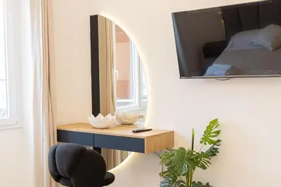 a room with a mirror and a chair and a bed at Luxury Rooms near St Peter in Rome