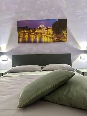 a bedroom with a large bed with a painting on the wall at The King's house - Rome in Rome