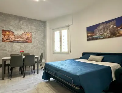 a bedroom with a bed and a table and chairs at The King's house - Rome in Rome