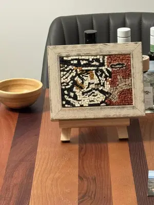 a quilt on a table with a wooden bowl at Al pozzo di Garibaldi in Rome