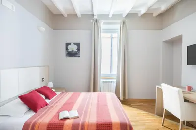a bedroom with a bed with two books on it at Spanish Steps House Vittoria in Rome