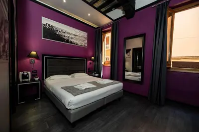 a purple bedroom with a bed and a mirror at Imperium Suite Navona in Rome