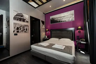 a bedroom with a purple wall with a bed at Imperium Suite Navona in Rome